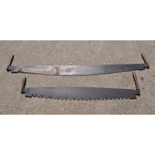 187 - A pair of antique double handled cross cut saws, different length approx. overall length including h... 