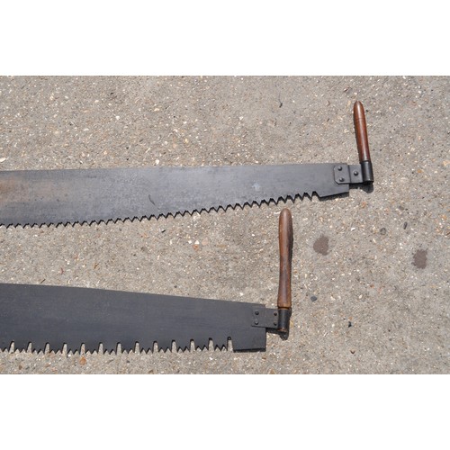 187 - A pair of antique double handled cross cut saws, different length approx. overall length including h... 