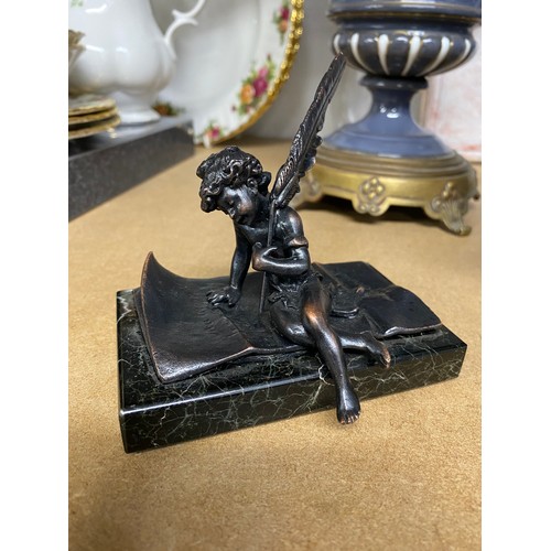 107 - Decorative paperweight depicting a cherub writing a letter with a feather quill on a marble base