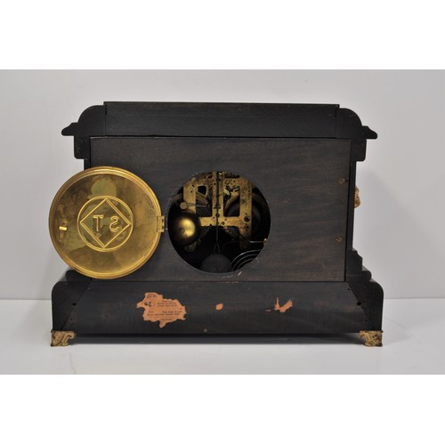 50 - An Antique Faux Slate, Ormolu, and Marble effect American Mantle Clock with twin columns and lion he... 