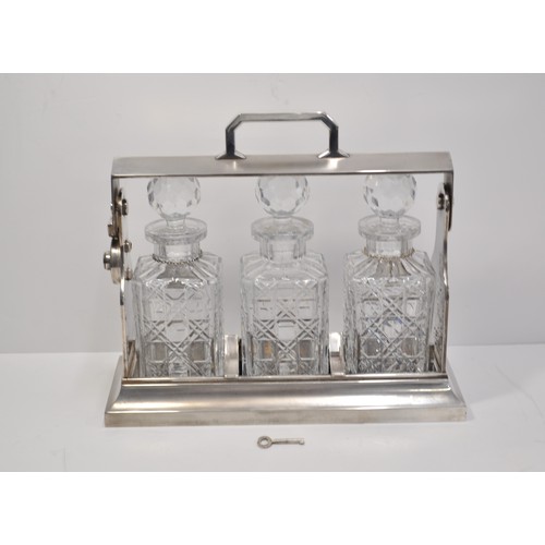 130 - Chrome effect tantalus with decanters, complete with key