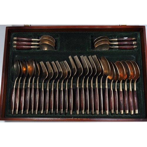 66 - 6 person cased canteen of cutlery finished in a gold tone with wooden handles