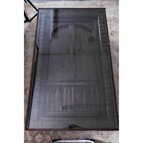 15 - A wooden coffee table,  with an Afghanistan carved door inset into the top, glazed top, and lower ce... 