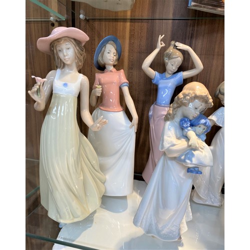 71 - Group of Llladro/Nao figures,  to include vintage sculpture of girl crossing arms carrying basket no... 