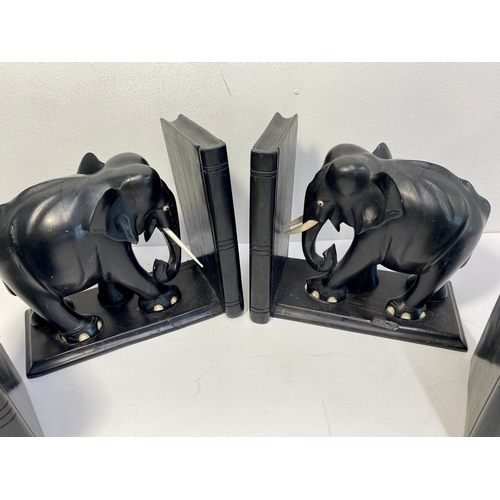 38A - Group of ebonised book ends in the form of elephants