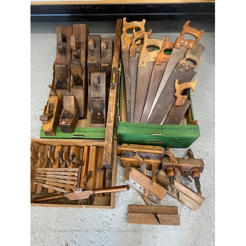 166 - A quantity of wood working tools to include saws, plough planes, rebate planes with blades, spirit l... 