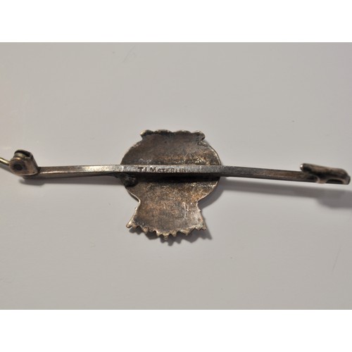 165 - Regimental naval brooch stamped Sterling together with cap badge, and other pin badge, together with... 