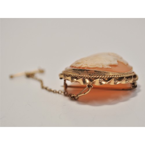 194 - 9ct gold cameo brooch with safety chain, approx length 4cm x 3.2cm wide. approx gross weight 10g