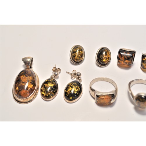 200 - Amber and silver jewellery items consisting of earrings, pendants and rings