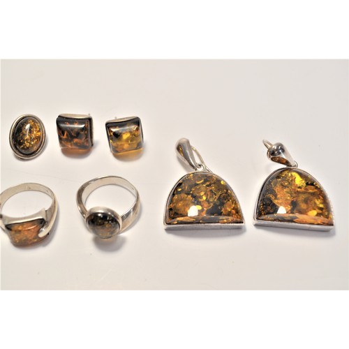 200 - Amber and silver jewellery items consisting of earrings, pendants and rings