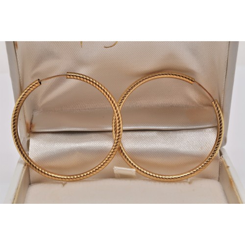 223 - Two pairs of gold hoop earrings, larger pair marked 375, approx. gross weight 3.6g