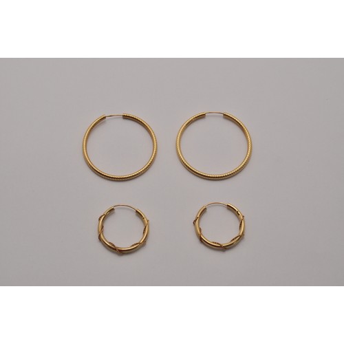 223 - Two pairs of gold hoop earrings, larger pair marked 375, approx. gross weight 3.6g