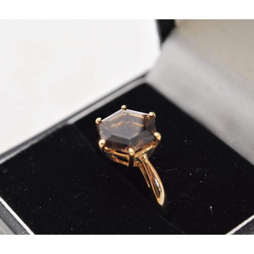 229 - 9ct gold ring, with large hexagonal cut smoky quartz marked 375 hallmarked Birmingham, approx. gross... 