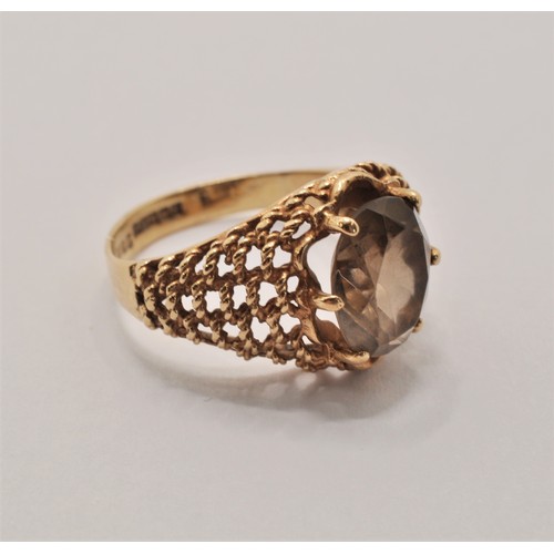 233 - 9ct yellow gold ring with smoky quartz central stone. Stamped 375, hallmarked Birmingham c. 1973. ap... 