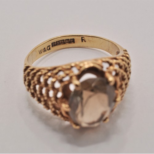 233 - 9ct yellow gold ring with smoky quartz central stone. Stamped 375, hallmarked Birmingham c. 1973. ap... 