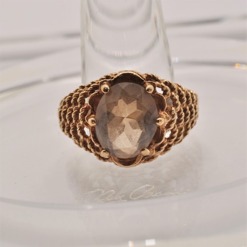 233 - 9ct yellow gold ring with smoky quartz central stone. Stamped 375, hallmarked Birmingham c. 1973. ap... 