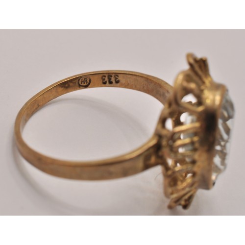 240 - 9ct yellow gold ring with a clear stone to the front in a flower design. marked 375, approx. gross w... 