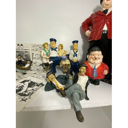 61 - A statue of Laurel & Hardy plus figures and figurines, together with a Hardy money box with stopper,... 