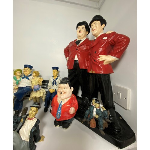 61 - A statue of Laurel & Hardy plus figures and figurines, together with a Hardy money box with stopper,... 