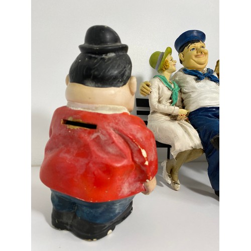 61 - A statue of Laurel & Hardy plus figures and figurines, together with a Hardy money box with stopper,... 