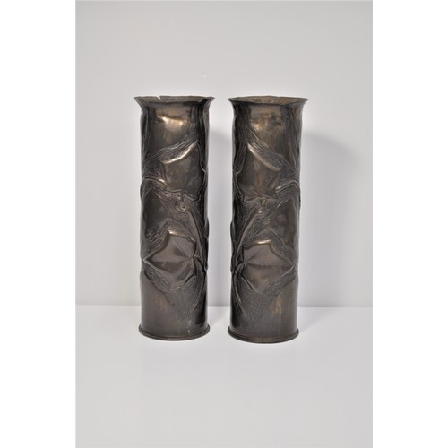 74 - A pair of brass shell casings decorated with ivy leaves.  Military markings to bases approx height 2... 