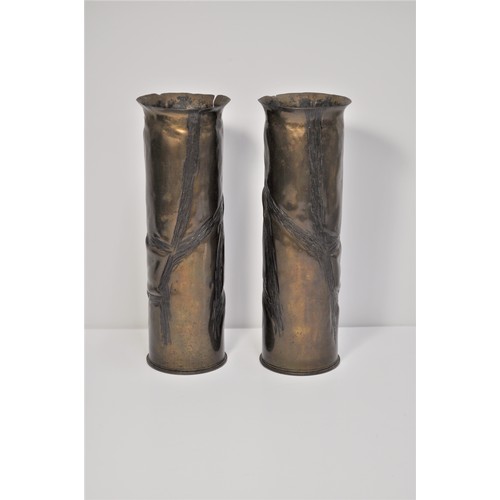 74 - A pair of brass shell casings decorated with ivy leaves.  Military markings to bases approx height 2... 