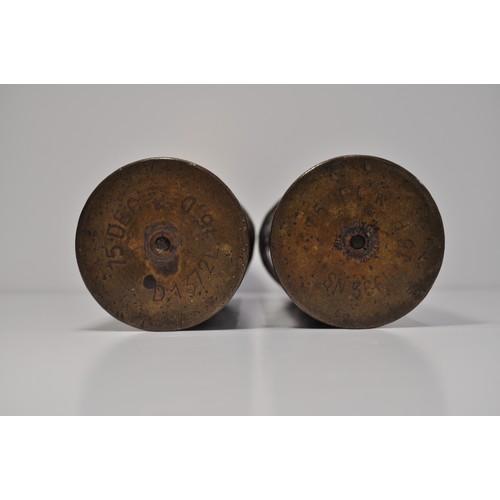 74 - A pair of brass shell casings decorated with ivy leaves.  Military markings to bases approx height 2... 