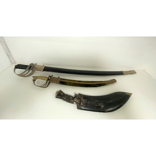 87 - x2 Indian  swords with decorative blades marked Made in India with scabbards, together with a Kukri.... 