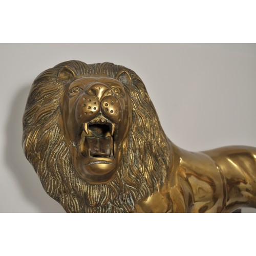 41 - Large roaring lion fireside statue in standing stance, approx height 41cm x 90cm. Very heavy item