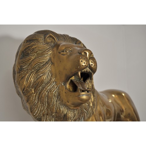 41 - Large roaring lion fireside statue in standing stance, approx height 41cm x 90cm. Very heavy item