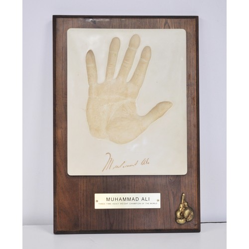 52 - Muhammad Ali hand implant plaque made by Silk Road Gifts and mounted on a wooden frame