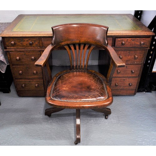 80 - Vintage oak campaign desk on casters together with an oak chair with a tilt swivel on brass casters ... 