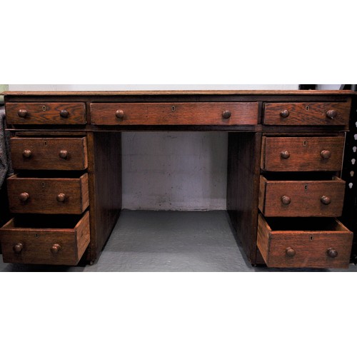 80 - Vintage oak campaign desk on casters together with an oak chair with a tilt swivel on brass casters ... 