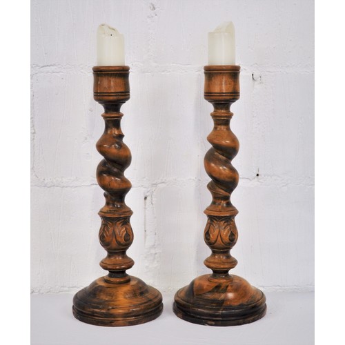 92 - Pair of chunky wooden pillar candle holders with a  barley twist and hand carved leaf design to stem... 