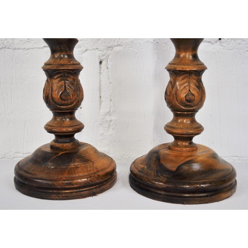 92 - Pair of chunky wooden pillar candle holders with a  barley twist and hand carved leaf design to stem... 