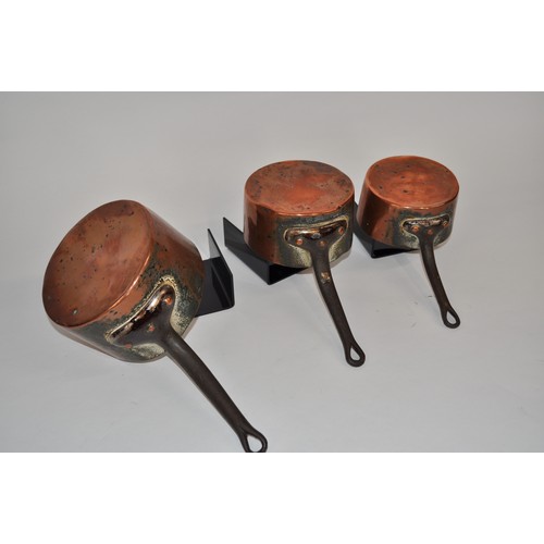 32 - Antique graduating copper saucepans with iron handles