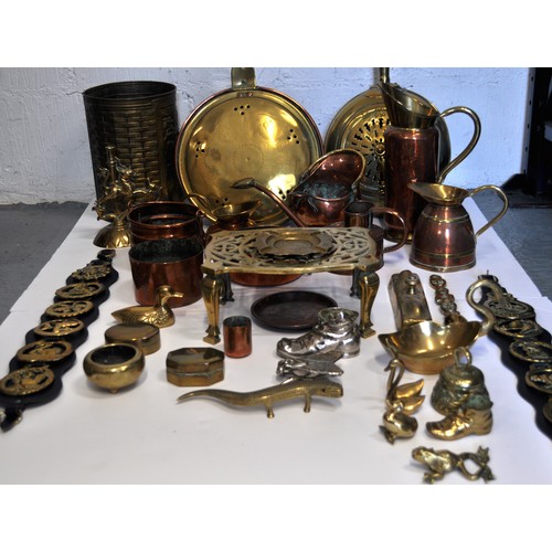 42 - A Mixed collection of copper and brassware items to include; jugs, bowls, watering can, mini coal sc... 