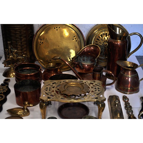 42 - A Mixed collection of copper and brassware items to include; jugs, bowls, watering can, mini coal sc... 