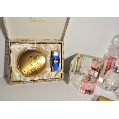 24A - A group of dressing table items to include glass perfume bottles, Stratton compact and lipstick hold... 