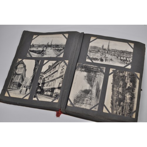 47 - A postcard album containing a mixture of military related postcards incl. WWI, tourist, coloured, co... 