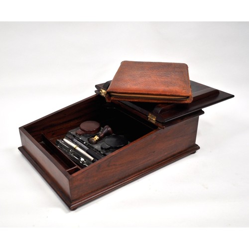 83 - Mahogany writing slope which includes contents consisting of  glass inkwells, pens, leather case