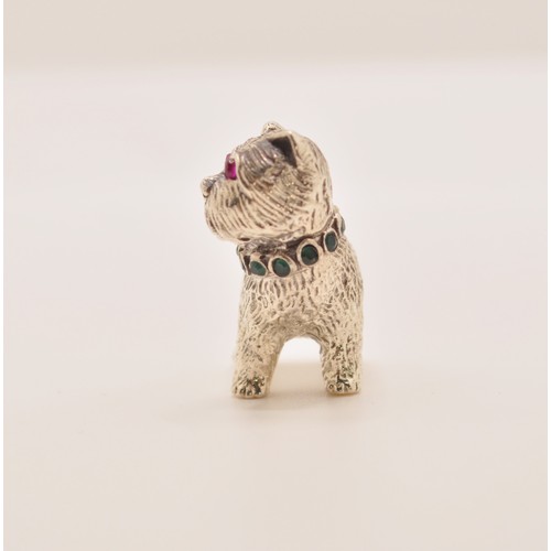 143 - A silver dog pin cushion with emerald collar and ruby eyes, stamped Sterling to base