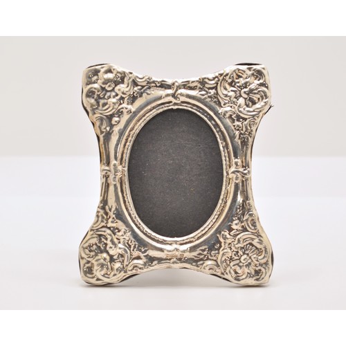 148 - A silver picture frame with floral decoration, hallmarked Birmingham