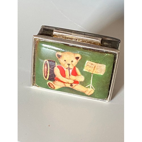 167 - A silver pill box, top panel with teddy bear playing instruments, hallmarked London stamped 925