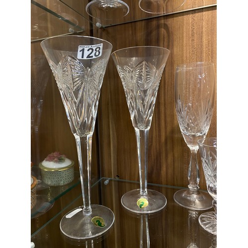 128 - A large quantity of mixed cut crystal glassware including a pair of Waterford Crystal champagne toas... 