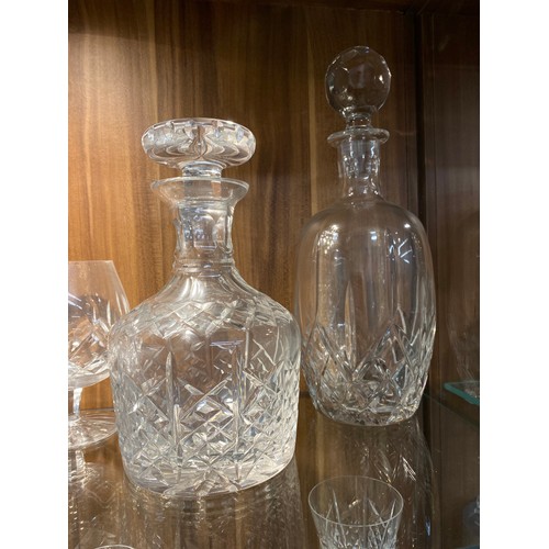 128 - A large quantity of mixed cut crystal glassware including a pair of Waterford Crystal champagne toas... 