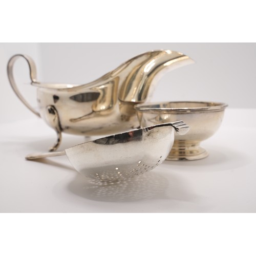 220 - Solid silver two piece tea strainer and holder hallmarked London by EBS and silver gravy boat, hallm... 