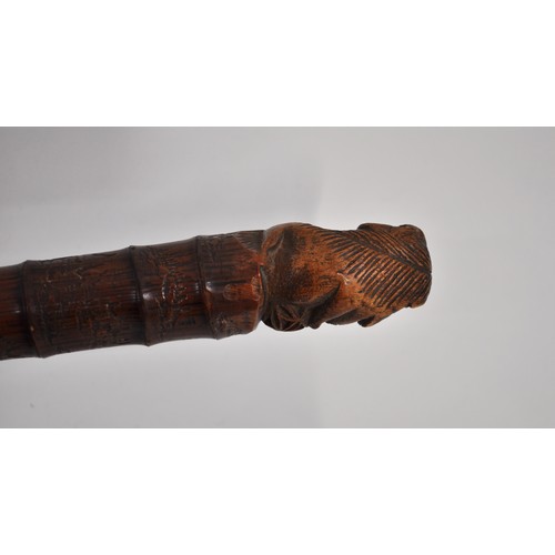 5 - Antique Chinese bamboo walking stick with carved pommel of a foo dog and hand-carved temple designs ... 