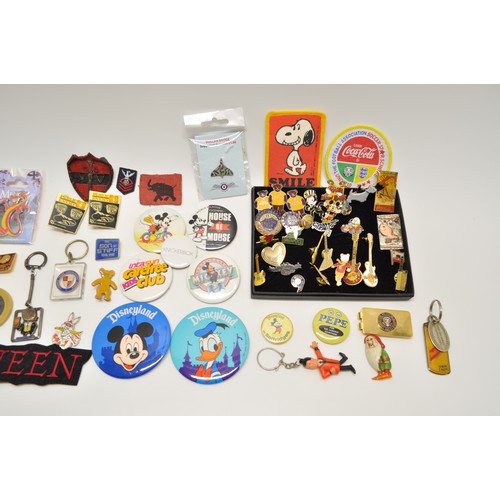 10 - An assortment of pin badges and keyrings to include Mickey Mouse, Hard Rock Cafe, Public Enemy, The ... 