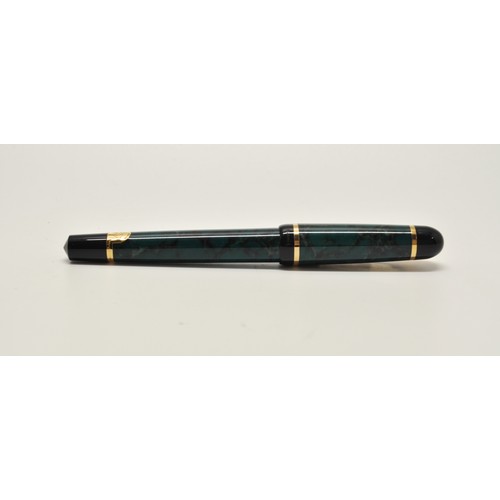 52 - A boxed Waterman Fountain Pen in mottled green marble effect, with leaflet and cartridge